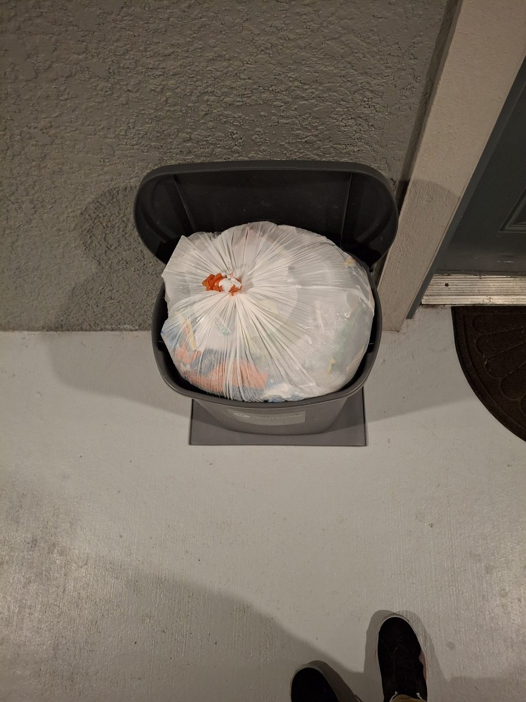 Trash bin with a tied bag