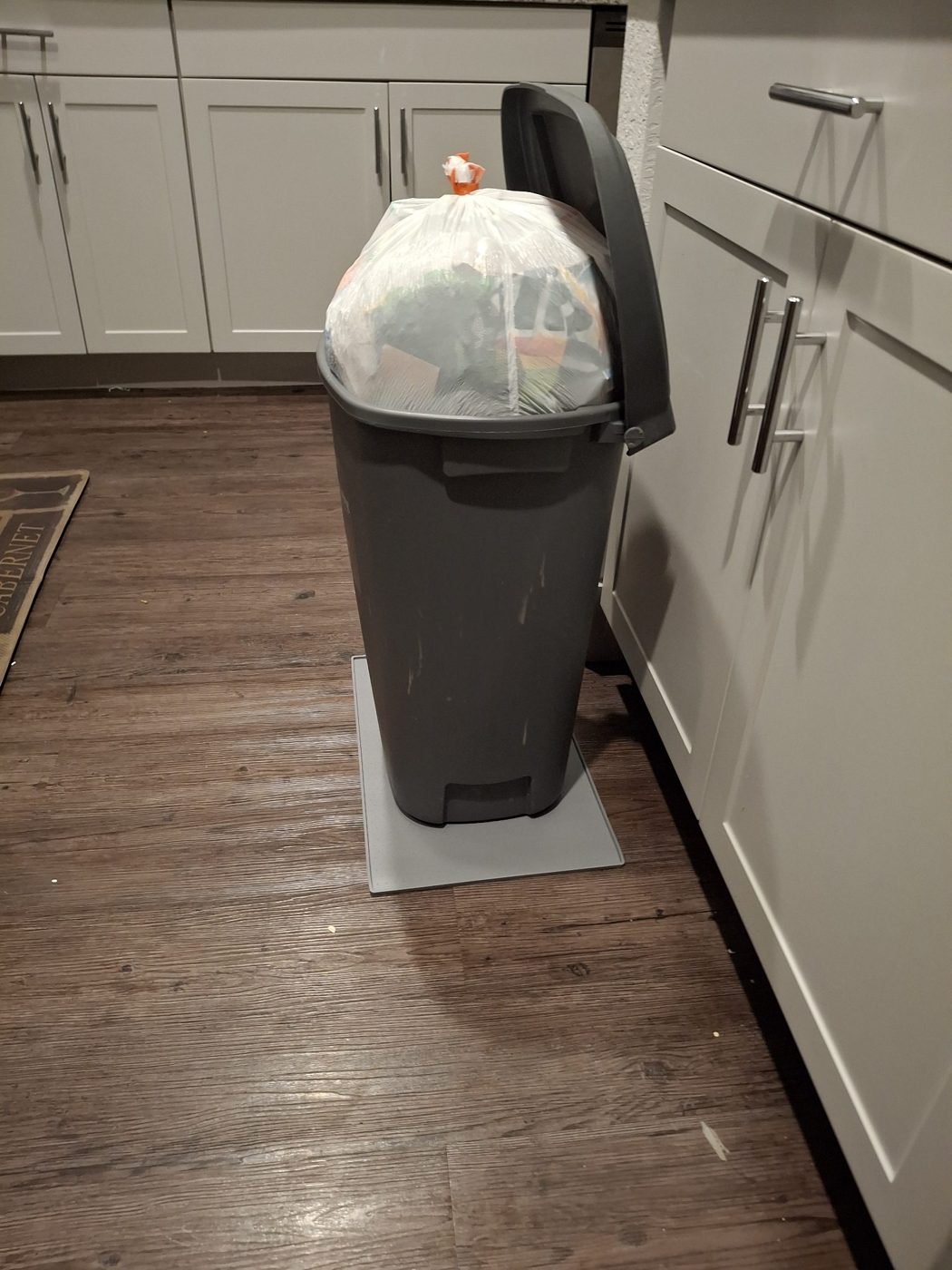 Trash bin with a tied bag