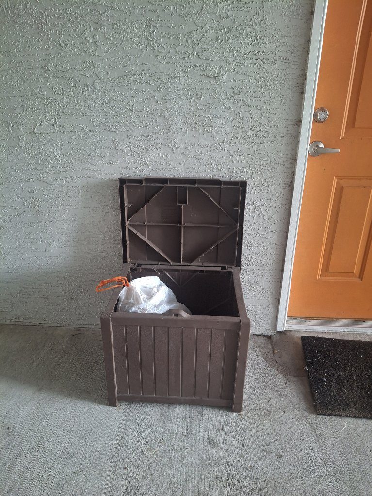 Valet trash bin beside an apartment door