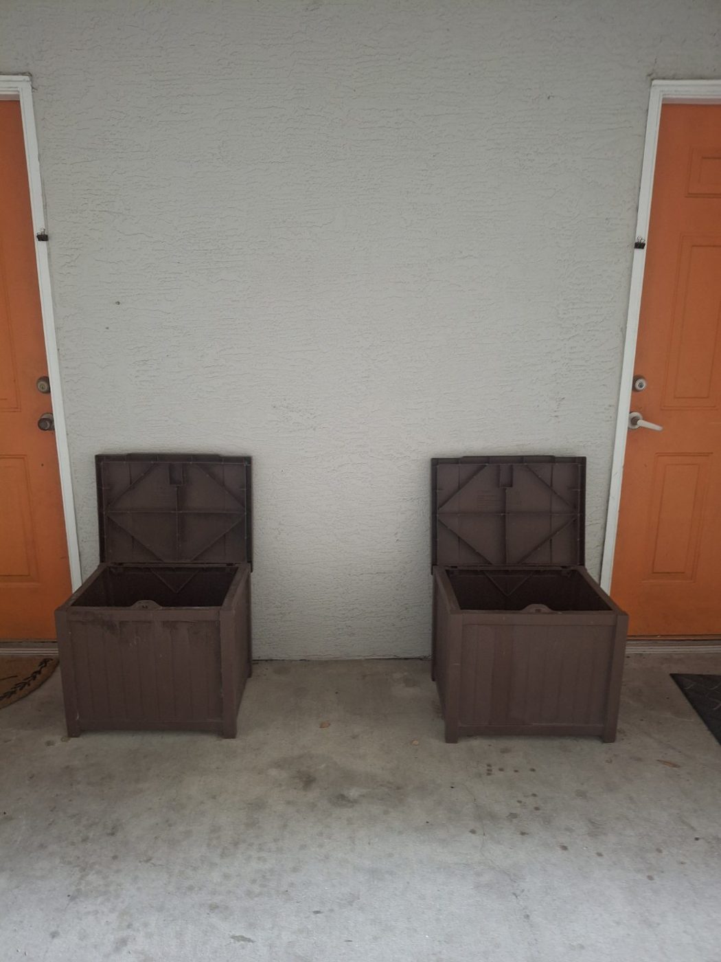 Two valet trash bins outside apartment doors