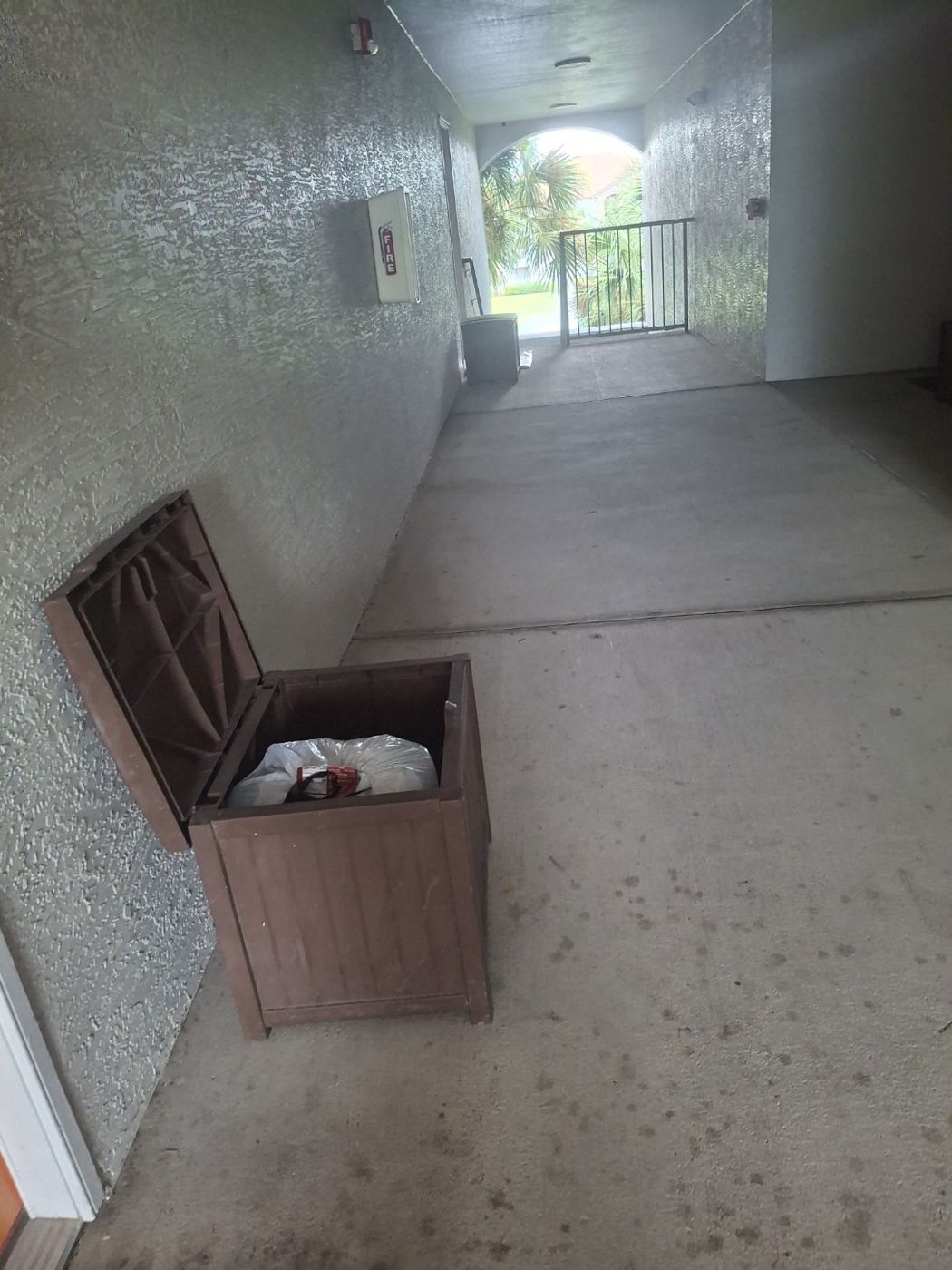 Valet trash bin along an apartment walkway